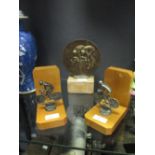 A bronze cycling trophy, together with a pair of cycling bookends (3)