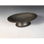 A Liberty & Co., Tudric pewter tazza, no. 01456, the oval dished top with decorated border to a