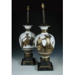 A pair of gilt decorated milk glass table lamps in the manner of Fornasetti, the baluster forms