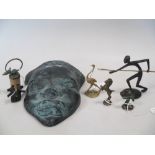 A collection of five miniature metal figures after Haganauer, together with a bronze wall mask and a