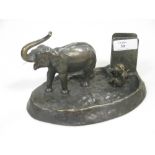 A bronze ashtray and matchbox holder mounted with an elephant and a monkey