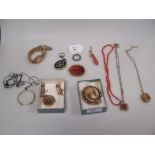 A group of jewellery to include coral beads, an agate brooch, hairwork brooch, an enamel and seed