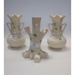 A Belleek spill vase modelled as a tree trunk, 17cm high, together with a pair of Belleek splill