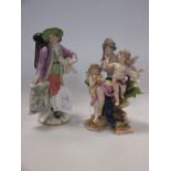 A Volkstedt figure group and a Vienna porcelain model of a traveller (2) 18cm high the larger