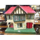 A cream and red Triang dolls house, 42 x 48 x 27cm