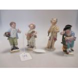 A Meissen model of a putto (restored) and three other small German figures bearing cross sword marks