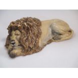 A Continental porcelain figure of a sleeping lion, 27.5cm