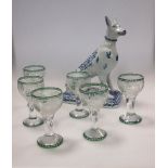 Six Bohemian green stemmed engraved liqueur glasses, and a Faience pottery model of a seated dog