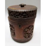A 19th century bamboo tea caddy, the cylindrical body carved with alternating relief panels of