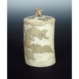 A late 19th/early 20th century ivory covered vase carved in low relief with rabbits playing below