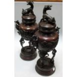 A pair of early 20th century bronze vases and covers, the latter with seated kirin surmounts, the