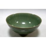 A 19th/20th century celadon bowl, the exterior moulded with painted leaves below the even olive