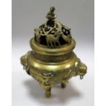 A 19th century polished bronze censer and pierced cover featuring monkeys holding peaches, stags and