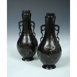 Suzuki Chokichi, a pair of inlaid bronze vases, the rims of the two handled bottle shapes inlaid