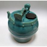 A Ming turquoise glazed pottery water vessel, a handle raised above the drum shape, a spout to one
