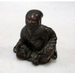 An early 20th century cupro-bronze figure of a God of Happiness, possibly Ebisu, he sits with his