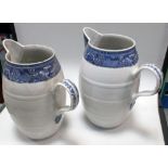 A pair of late 18th century barrel shaped jugs, the blue Fitzhugh type rim bands above simulated