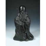 A late 19th/early 20th century bronze figure of Fukurokuju, he wears a robe cast in relief with