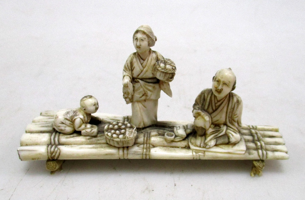 Toshikazu', an early 20th century ivory raft group, the sectional figures of the father seated