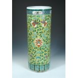 A 19th century yellow ground stick stand, the cylindrical exterior painted with scrolling lotus