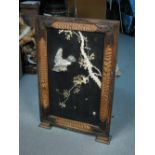A late 19th/early 20th century framed black lacquer panel inlaid in bone, stagshorn and mother of