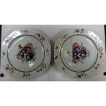 A pair of 18th century armorial plates, the arms central to a chain gilt on the cavetto with