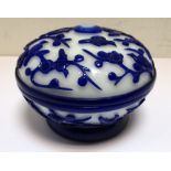 A Pekin blue overlay milk glass box and cover, the footed bun shape carved in relief with birds
