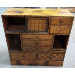 An early 20th century specimen wood parquetry cabinet, the rectangular front with a configuration of