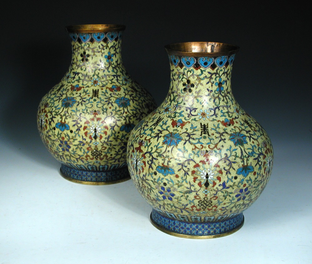 A pair of mid 19th century cloisonne bottle vases, the yellow grounds decorated with lotus scrolling