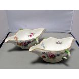 A pair of Meissen double lipped sauce boats with rustic side handles, the bodies painted with sprigs