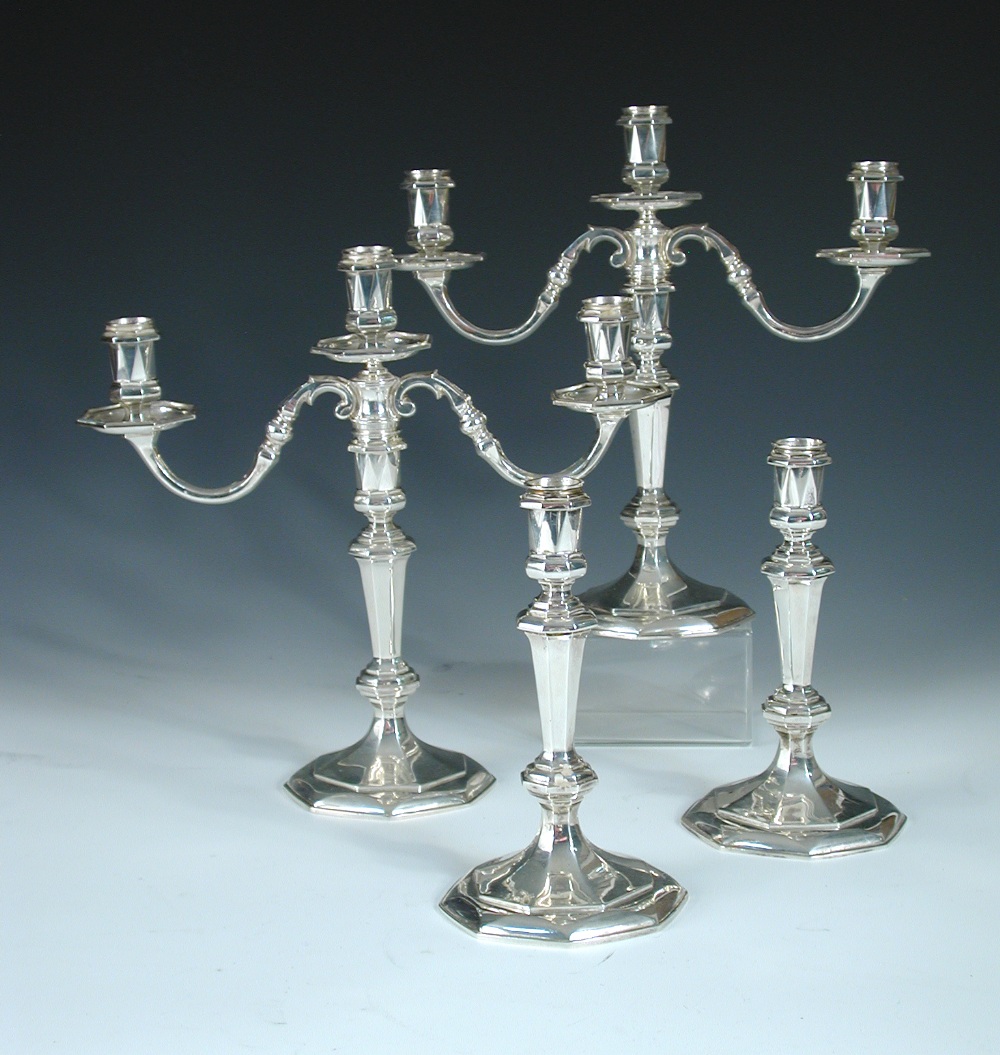 A pair of 18th century style silver three light candelabra and a matching pair of single