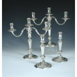 A pair of 18th century style silver three light candelabra and a matching pair of single