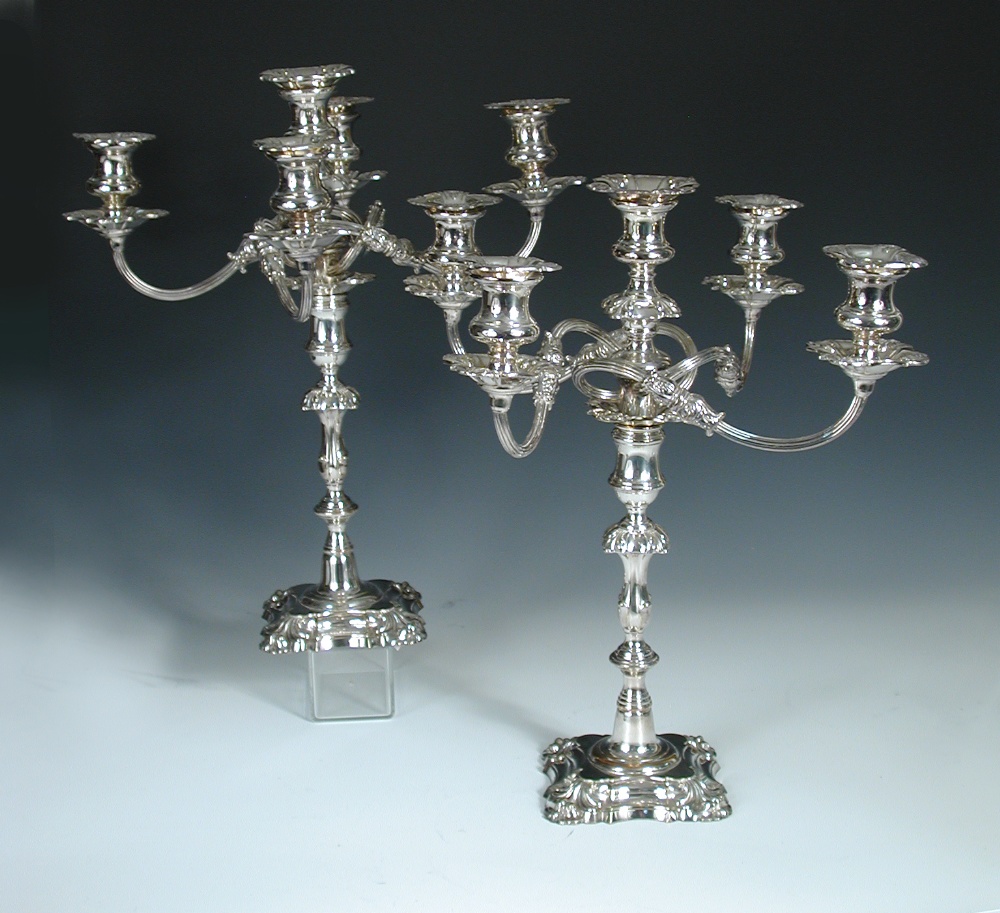 A pair of Edwardian electroplate on copper five light candelabra, unmarked, raised on shaped