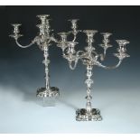 A pair of Edwardian electroplate on copper five light candelabra, unmarked, raised on shaped