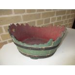 A painted coopered wood 'Monteith' shaped planter, the interior painted red and the exterior