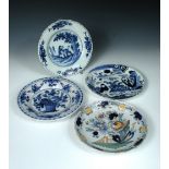 Three 18th century Delft blue and white plates together with another polychrome, the former