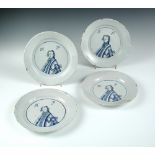 Four mid-18th century English Delft blue and white 'King of Prussia' plates, each painted with a