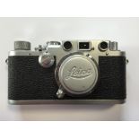 A leather cased 1951 Leica IIIF camera with Elmar f=5 1:3.5 'm' fit lens, the camera numbered 568524