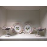 A Meissen dessert service, each piece painted with birds perched in trees within arcaded rims,