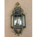 A brass mounted and black painted tin plate hall lantern, with cast and turned finials 82cm (32in)