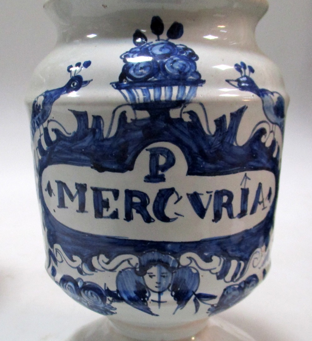 A pair and another mid 18th century Delft blue and white drug jar, the pair raised on flared