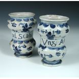 Two 18th century Savona blue and white drug jars, centrally named between bun shaped mouldings
