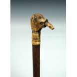 A stag's horn handled walking cane dated 1654, the dog's head handle with a salmon in its mouth, its