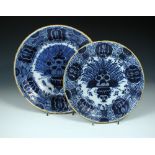 Der Porcelyne Claeuw', two 18th century Dutch Delft blue and white dishes, each painted with the '