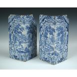 Two 18th century blue and white Delft corner stones from a stove, each with Rococo framed scenes