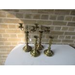 A pair of 18th century French or Dutch brass candelabra and a matching pair of candlesticks, each