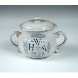 A London Delft blue and white posset pot and cover, dated 1692 below W over HA, the body inscribed