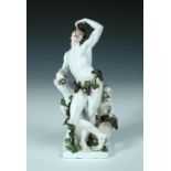 A Meissen Bacchanalian figure of Autumn from a set by J.J. Kaendler, the main figure leaning on a