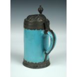 An 18th century German turquoise pottery tankard the pewter mounts dated 1778, the lid cast and