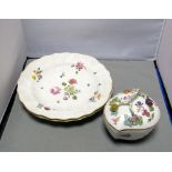 A pair of Meissen plates together with a peach shaped box and cover, the first painted with sprigs